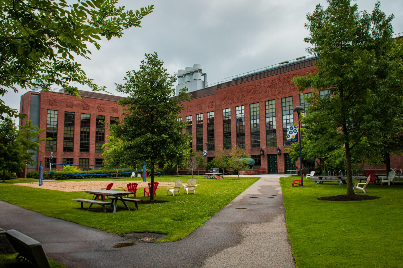 A large brick building on the Harvard University campus with a grassy lawn in front, in Cambridge, Massachusetts